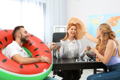 Photo of Beautiful young couple visiting travel agency office