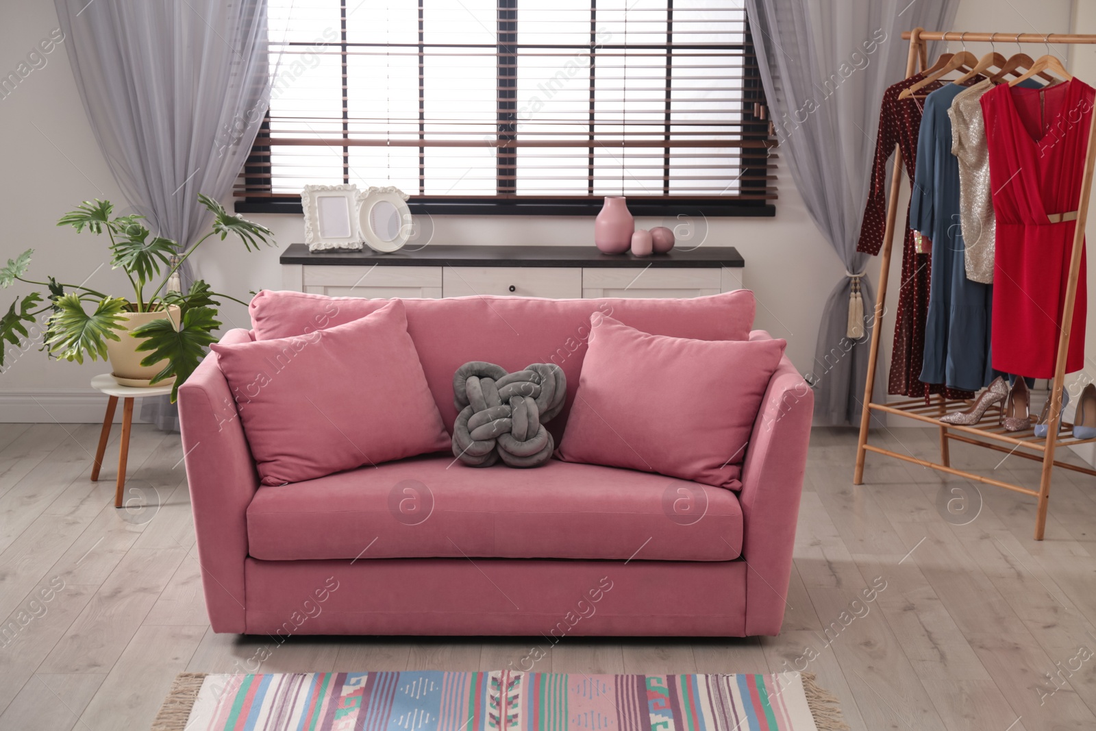 Photo of Comfortable sofa near window in stylish living room interior