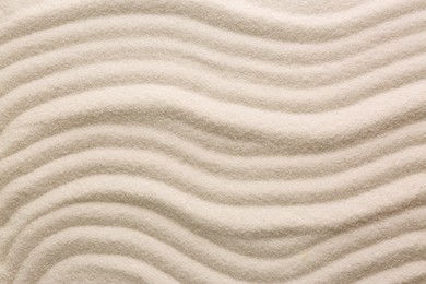 Photo of White sand with pattern as background, top view. Concept of zen and harmony