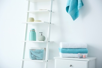 Photo of Room interior with clean towels and toiletries