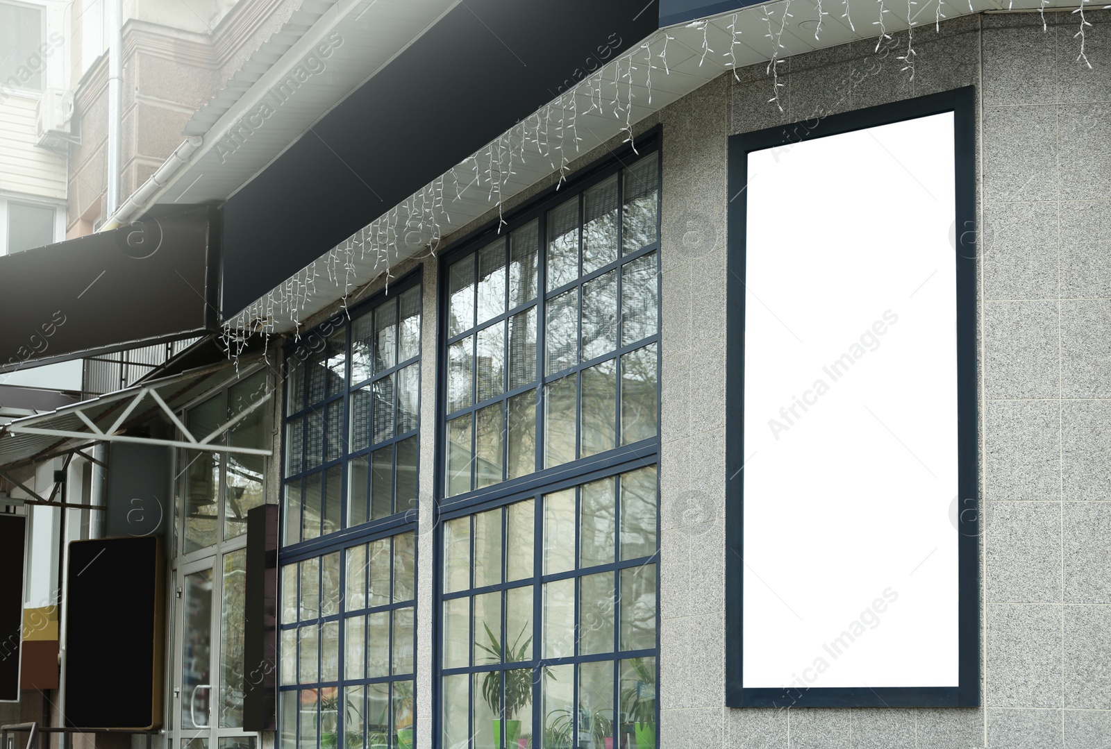 Photo of Blank banner on building facade outdoors. Advertising board design