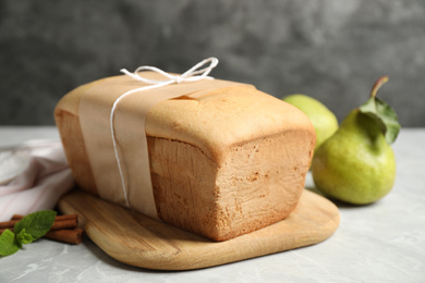 Photo of Tasty tied pear bread on light table, closeup. Homemade cake