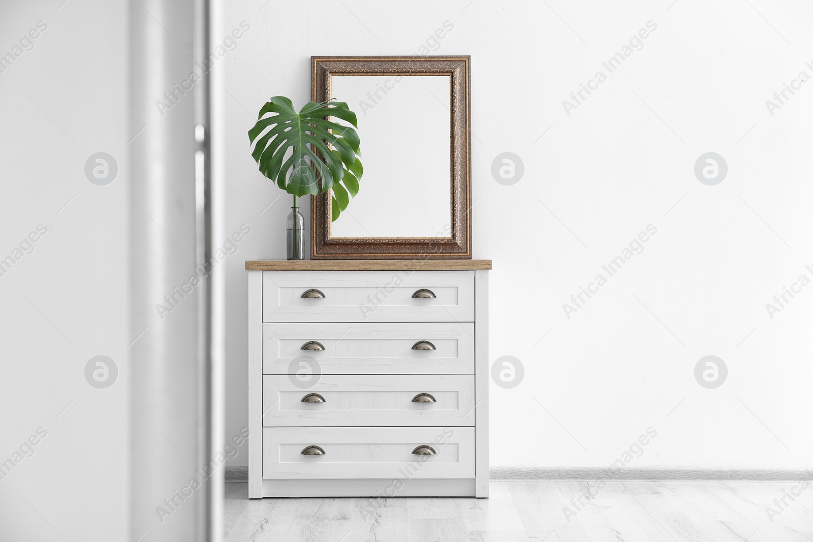 Photo of Elegant room interior with mirror on wooden cabinet