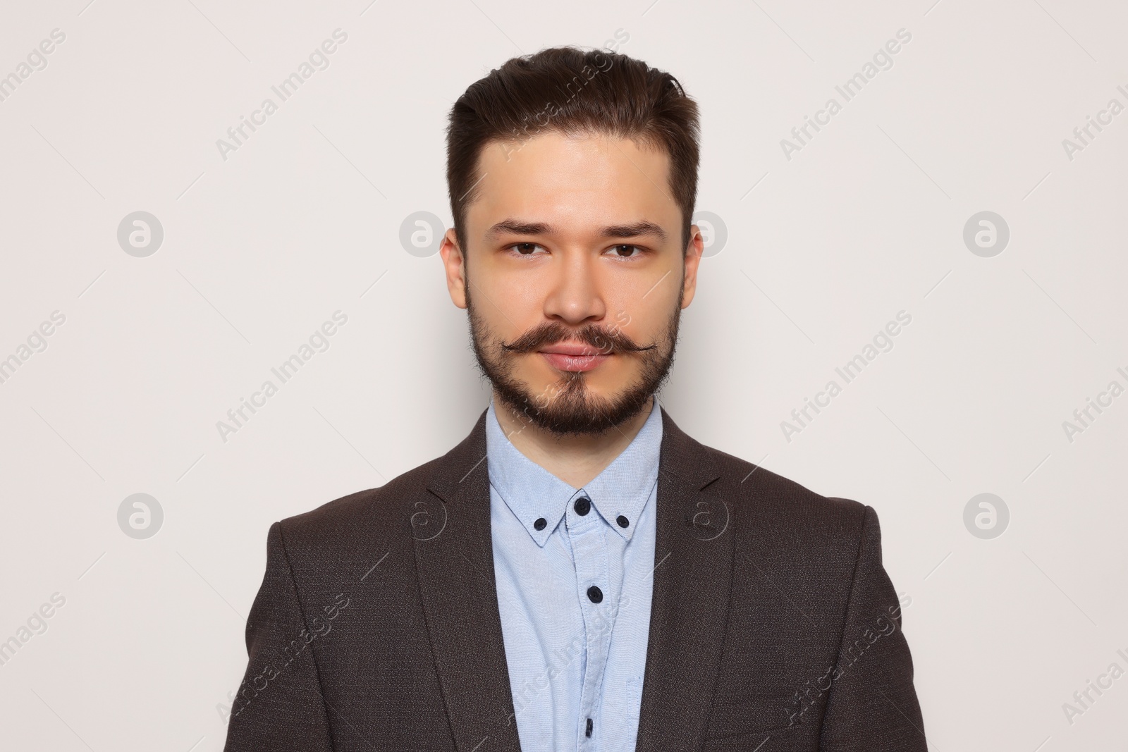 Photo of Handsome man in suit on light grey background