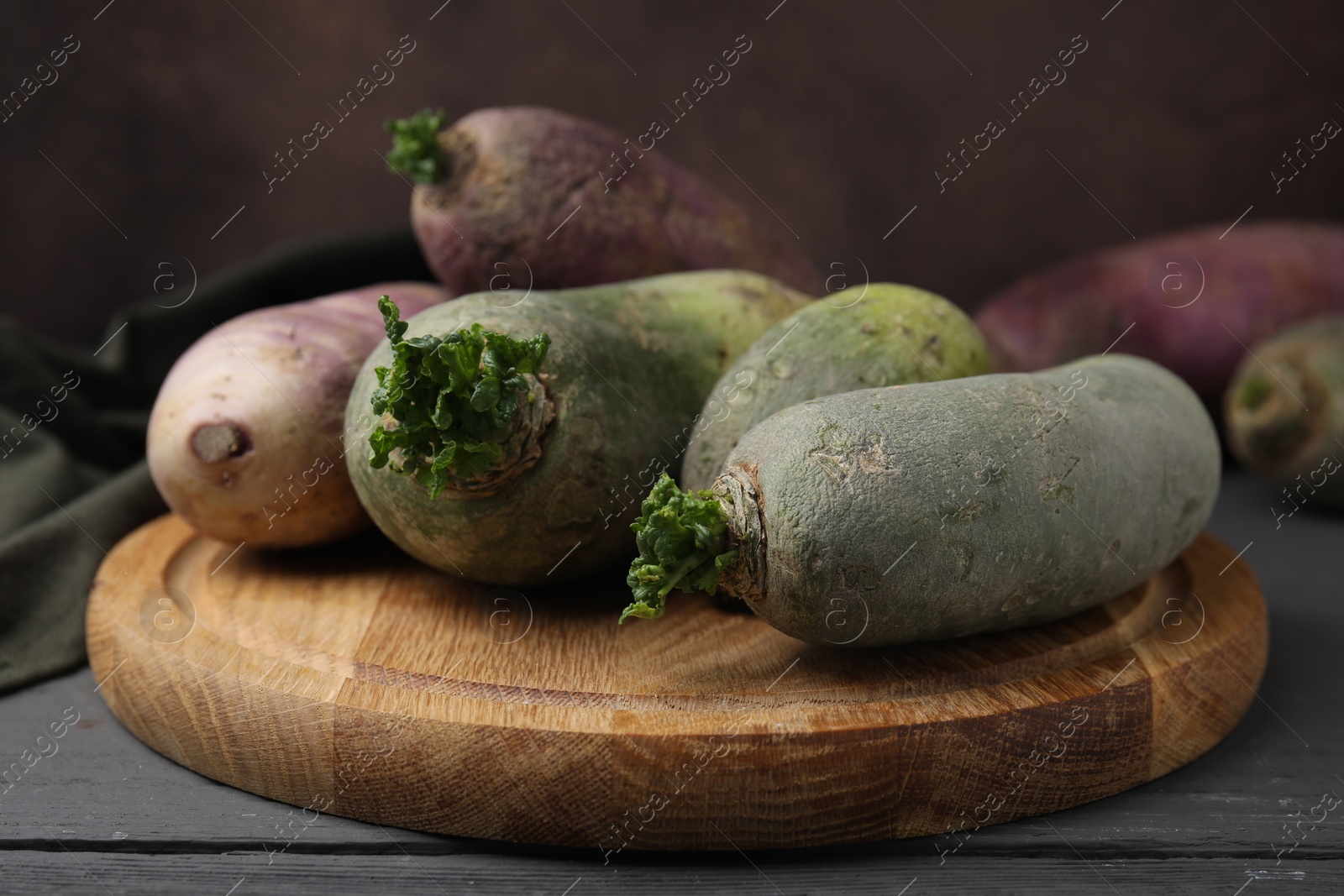 Photo of Green and purple daikon radishes on table, closeup