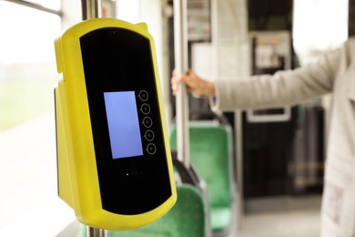 Photo of Contactless fare payment device in public transport, space for text