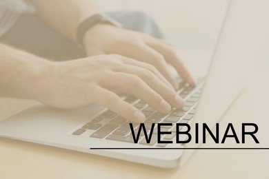 Webinar concept. Man working with laptop at table indoors, closeup