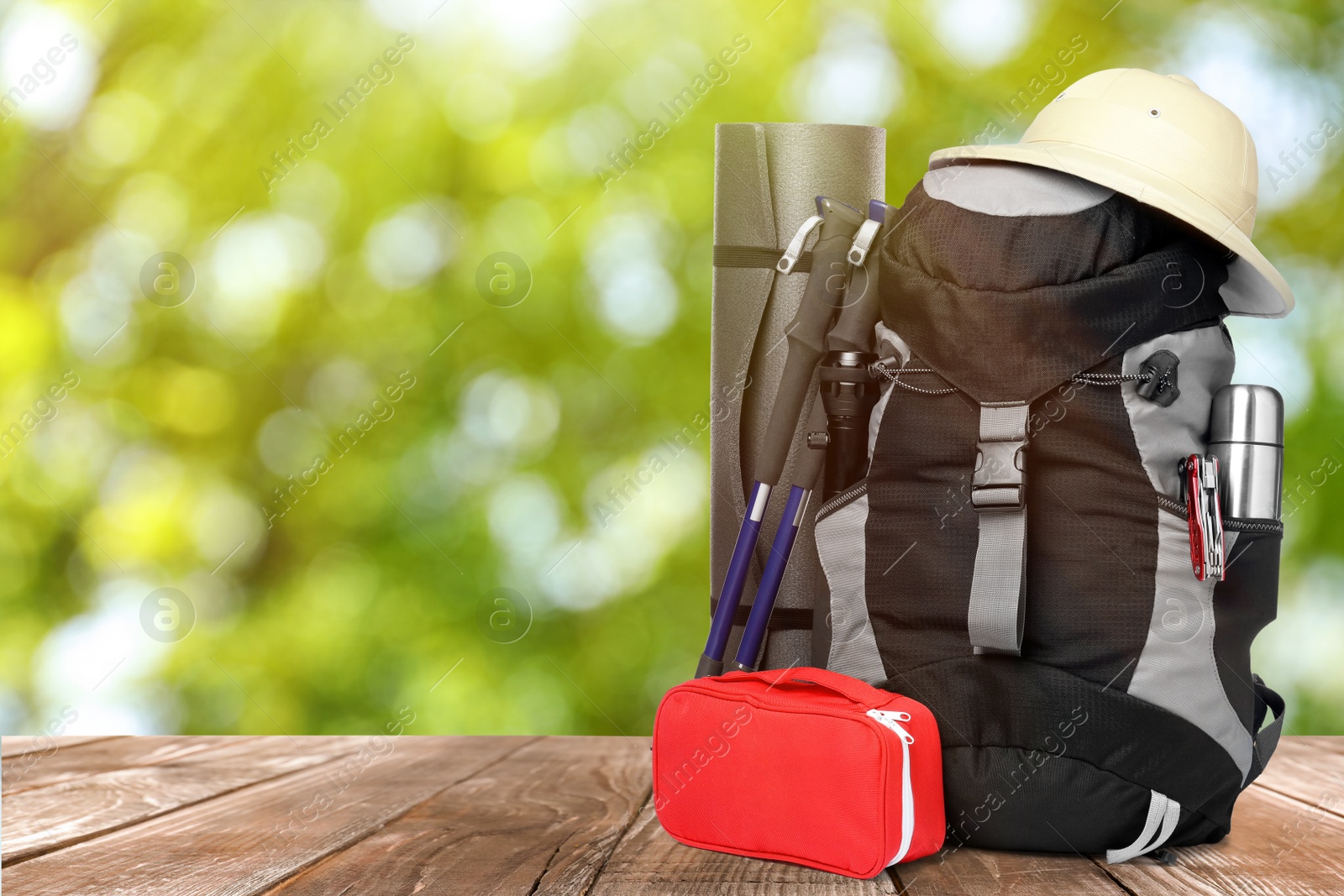 Image of Camping equipment for tourist on wooden surface outdoors