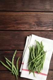 Photo of Fresh green beans on wooden table, flat lay. Space for text