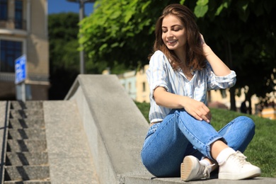 Beautiful young woman outdoors on sunny day. Space for text