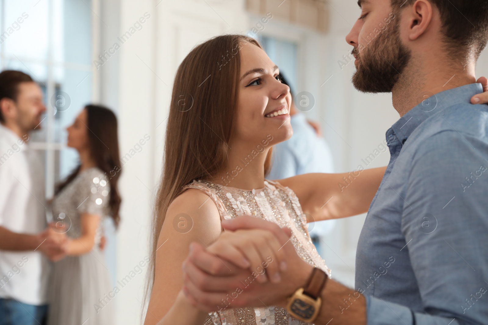 Photo of Lovely young couple dancing together at party