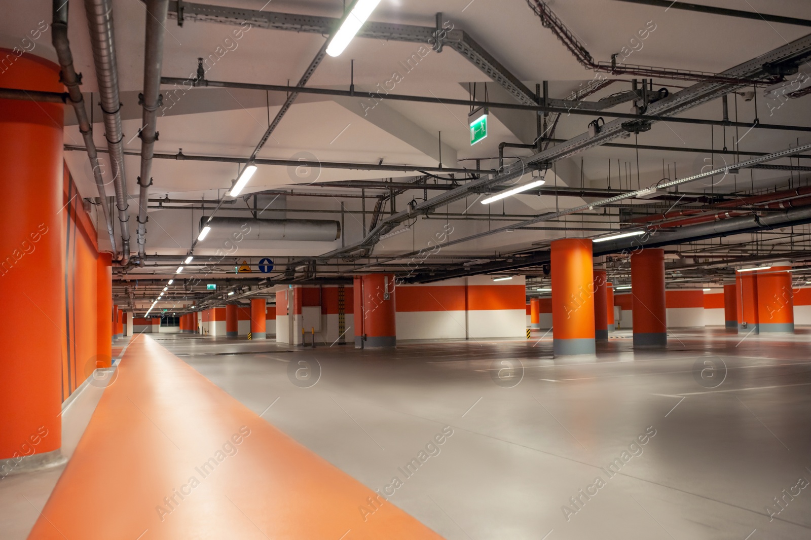 Photo of Empty car parking garage with lighting and columns