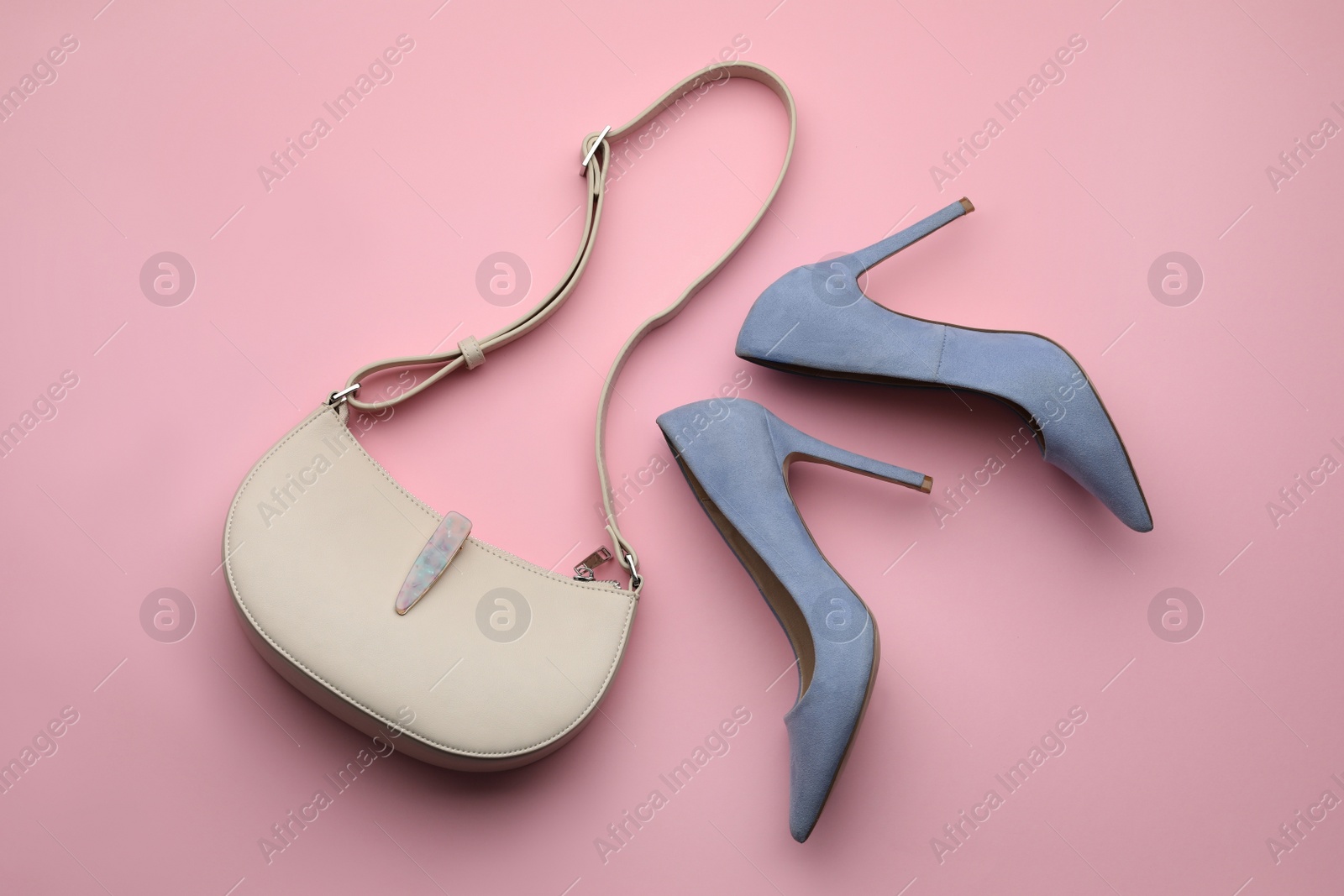 Photo of Stylish woman's bag and shoes on pink background, flat lay