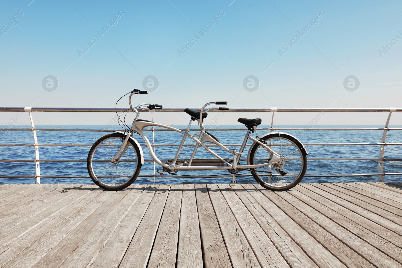 Photo of Tandem bike near sea on sunny day