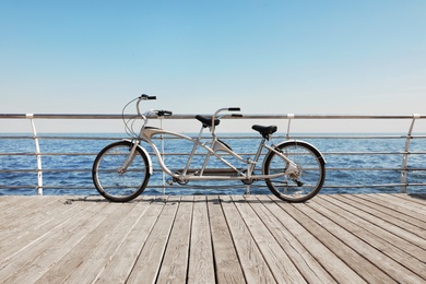 Photo of Tandem bike near sea on sunny day