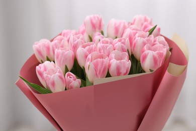 Photo of Beautiful bouquet of fresh pink tulips on blurred background, closeup