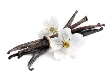 Photo of Vanilla sticks and flowers on white background