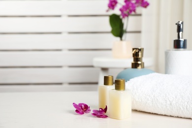 Photo of Composition with orchid flowers and spa accessories on table indoors. Space for text