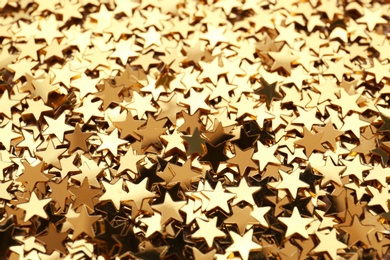 Photo of Confetti stars as background, closeup. Christmas celebration