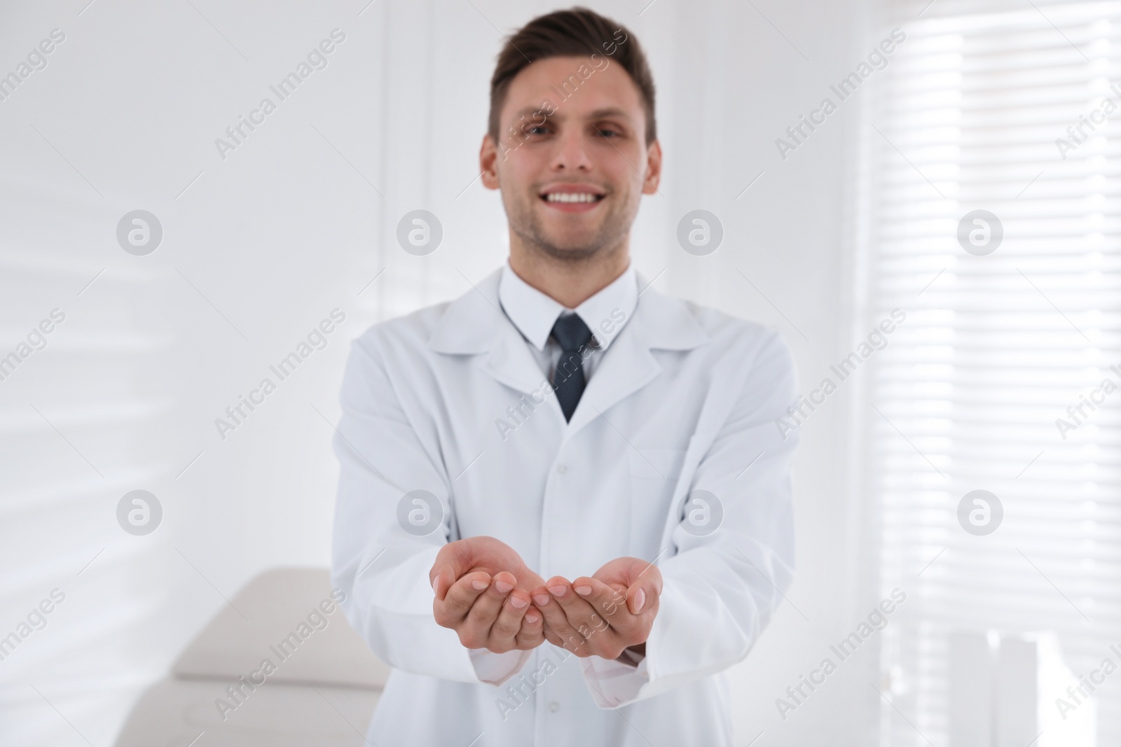 Photo of Dentist holding something in clinic, focus on hands