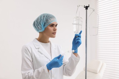 Nurse setting up IV drip in hospital