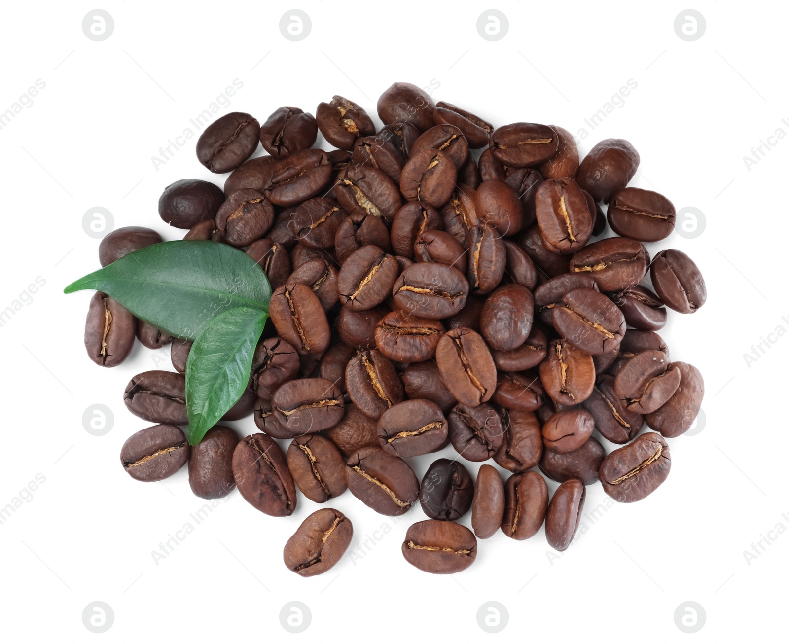 Photo of Pile of roasted coffee beans with fresh leaves on white background, top view