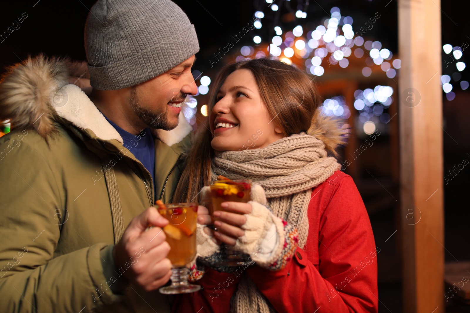 Photo of Happy couple with mulled wine at winter fair