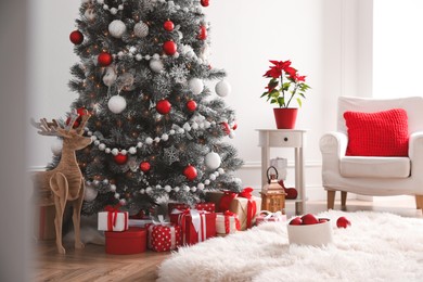 Stylish room interior with Christmas tree and presents