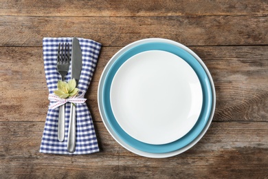 Beautiful table setting on wooden background, flat lay