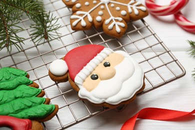Photo of Tasty homemade Christmas cookies and decor on white wooden table, closeup