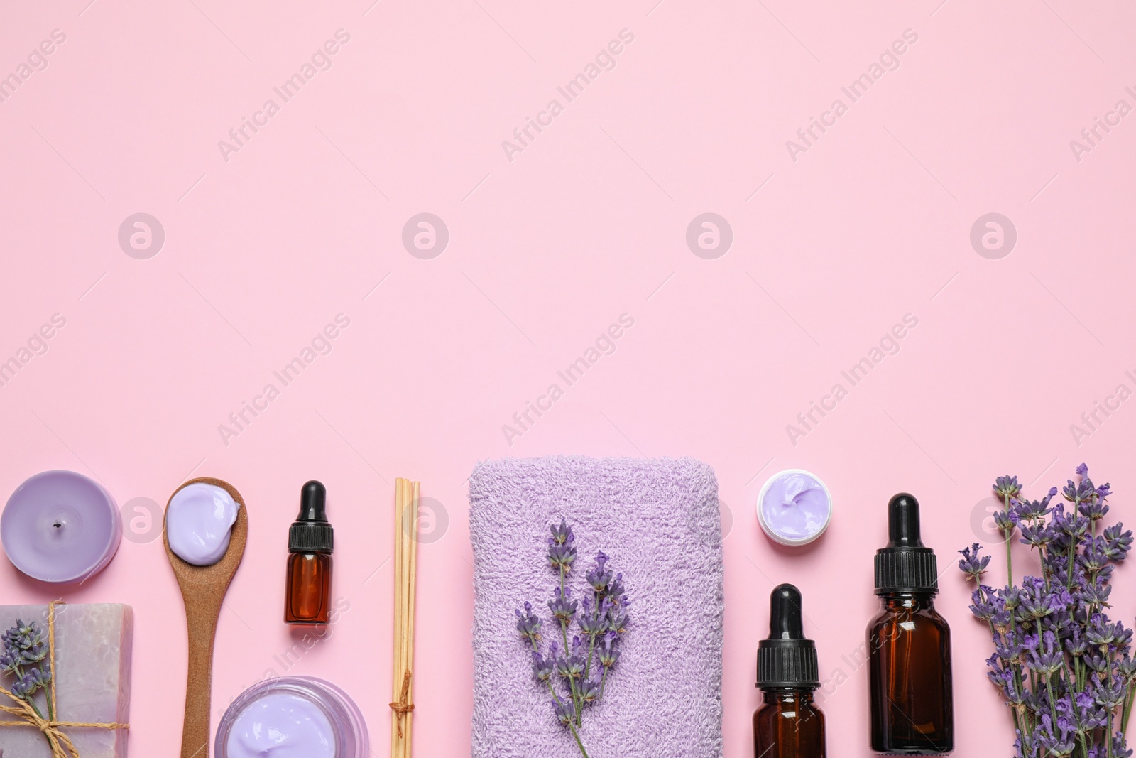 Photo of Cosmetic products and lavender flowers on pink background, flat lay. Space for text