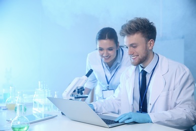 Photo of Scientists working in laboratory, space for text. Chemistry concept