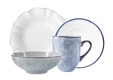Set of stylish ceramic dinnerware on white background