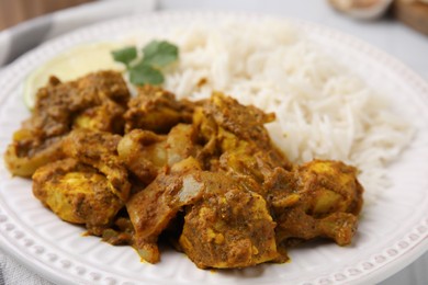 Photo of Delicious chicken curry with rice on table, closeup