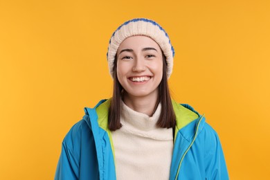 Photo of Portrait of beautiful woman smiling on orange background