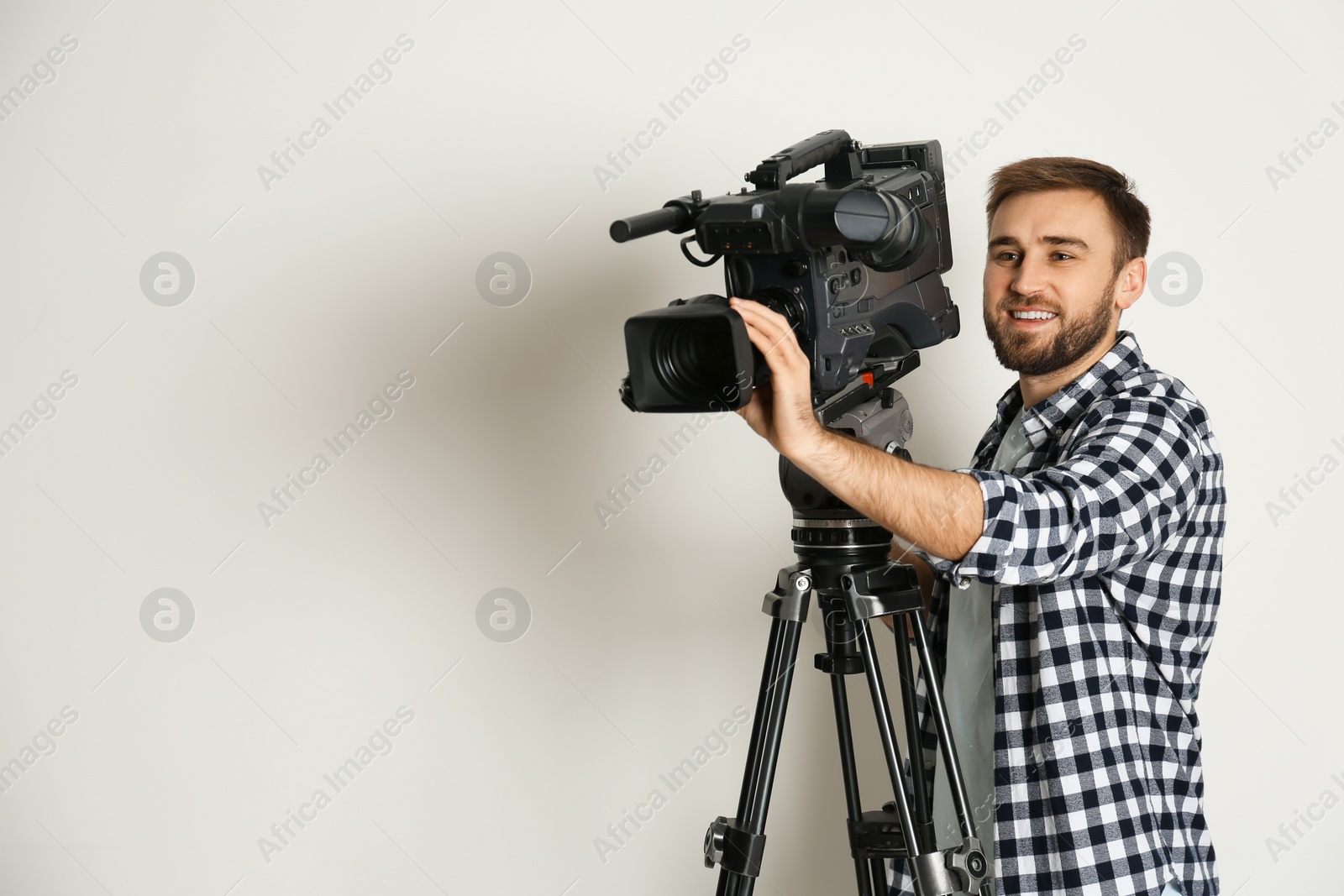 Photo of Operator with professional video camera on white background