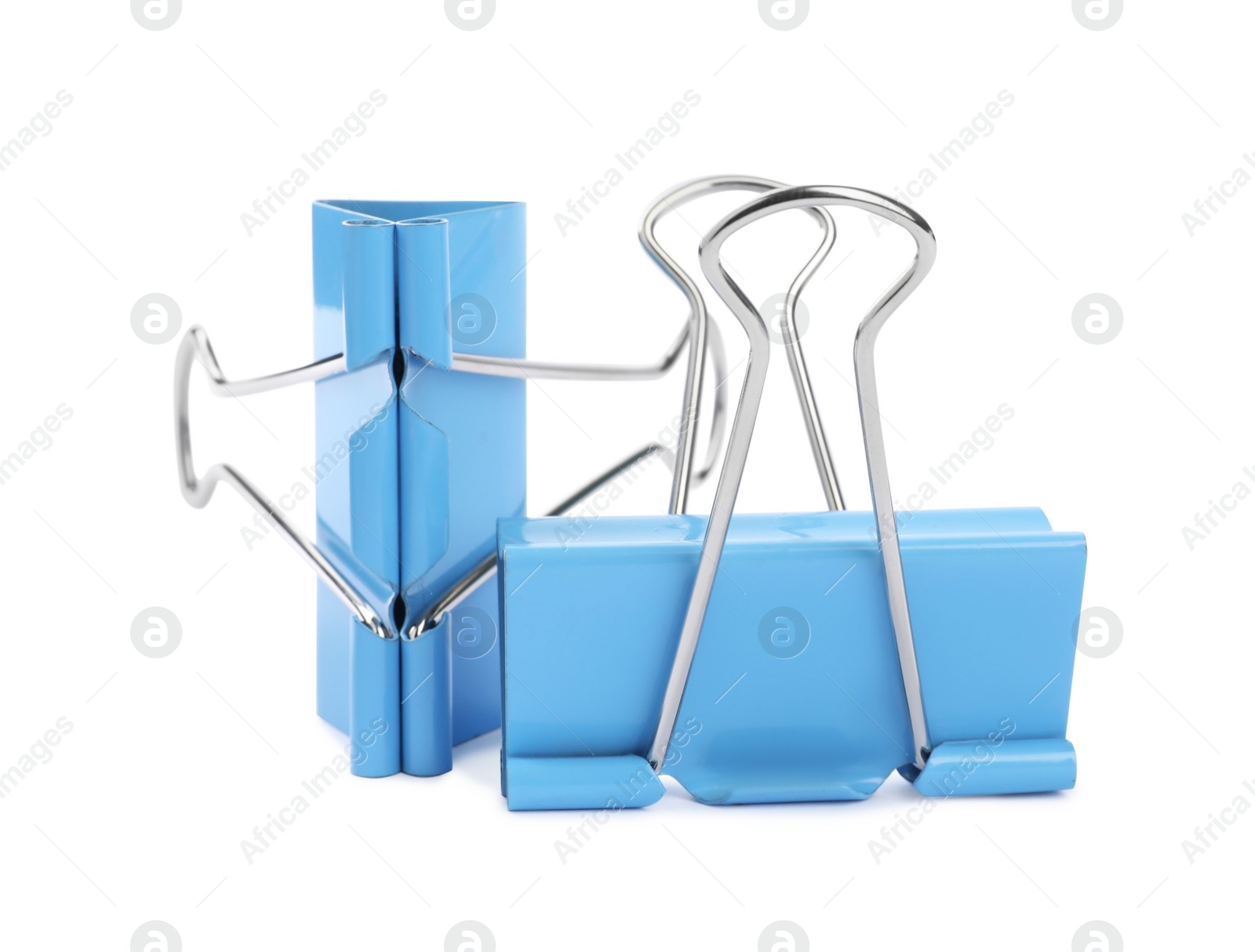 Photo of Light blue binder clips on white background. Stationery