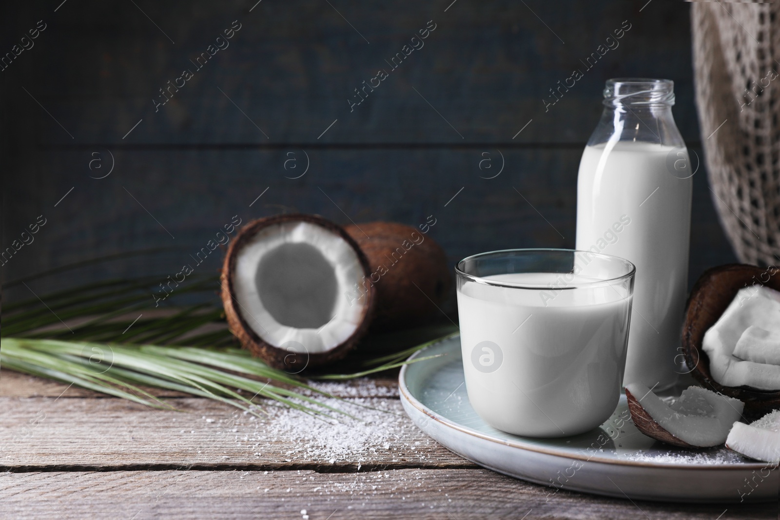 Photo of Composition with coconut milk on wooden table, space for text