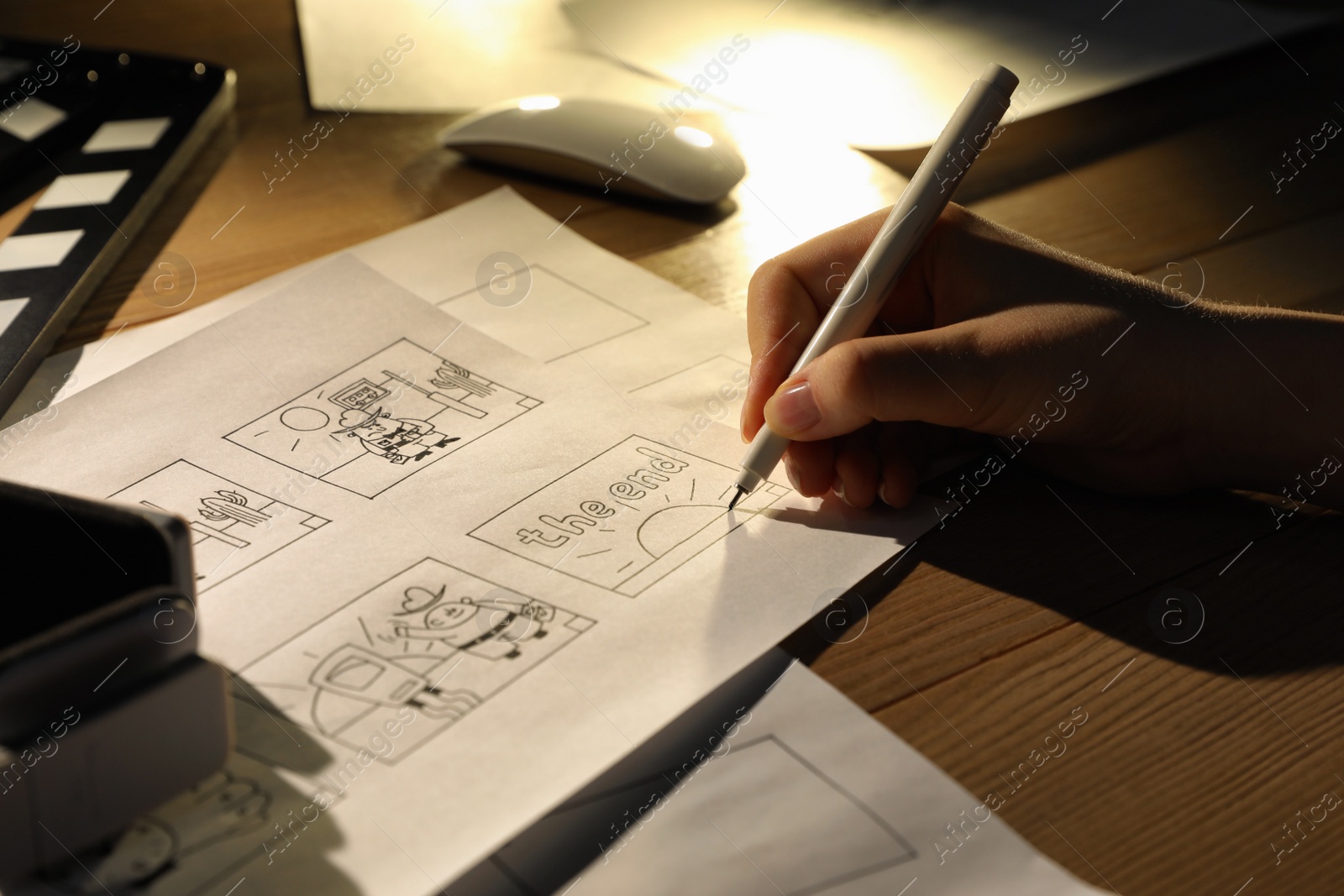 Photo of Woman drawing cartoon sketches at workplace, closeup. Pre-production process