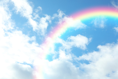 Image of Picturesque view of beautiful rainbow and blue sky on sunny day 