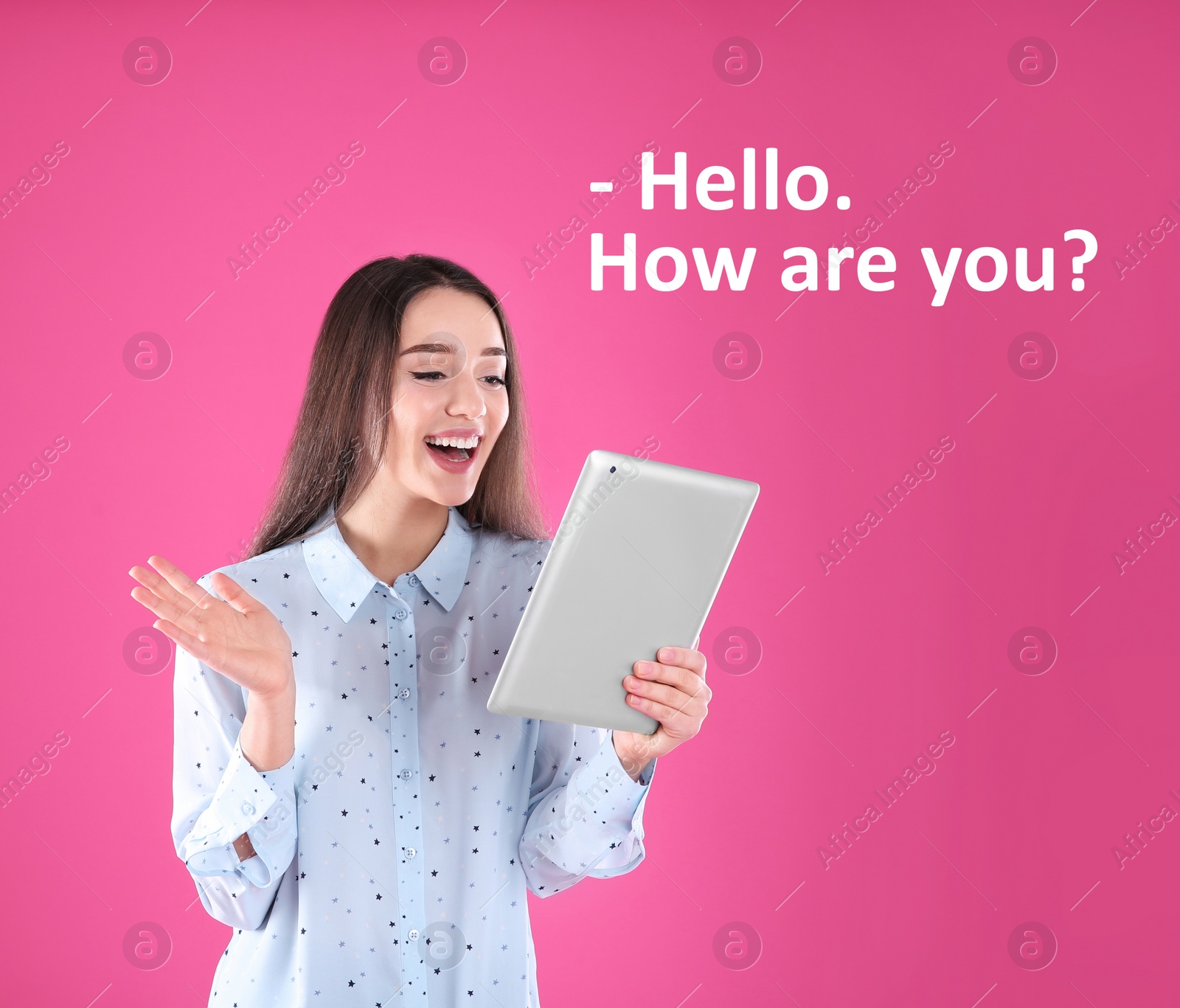 Image of Young woman saying Hello. How Are You? in English using tablet for video chat on pink background