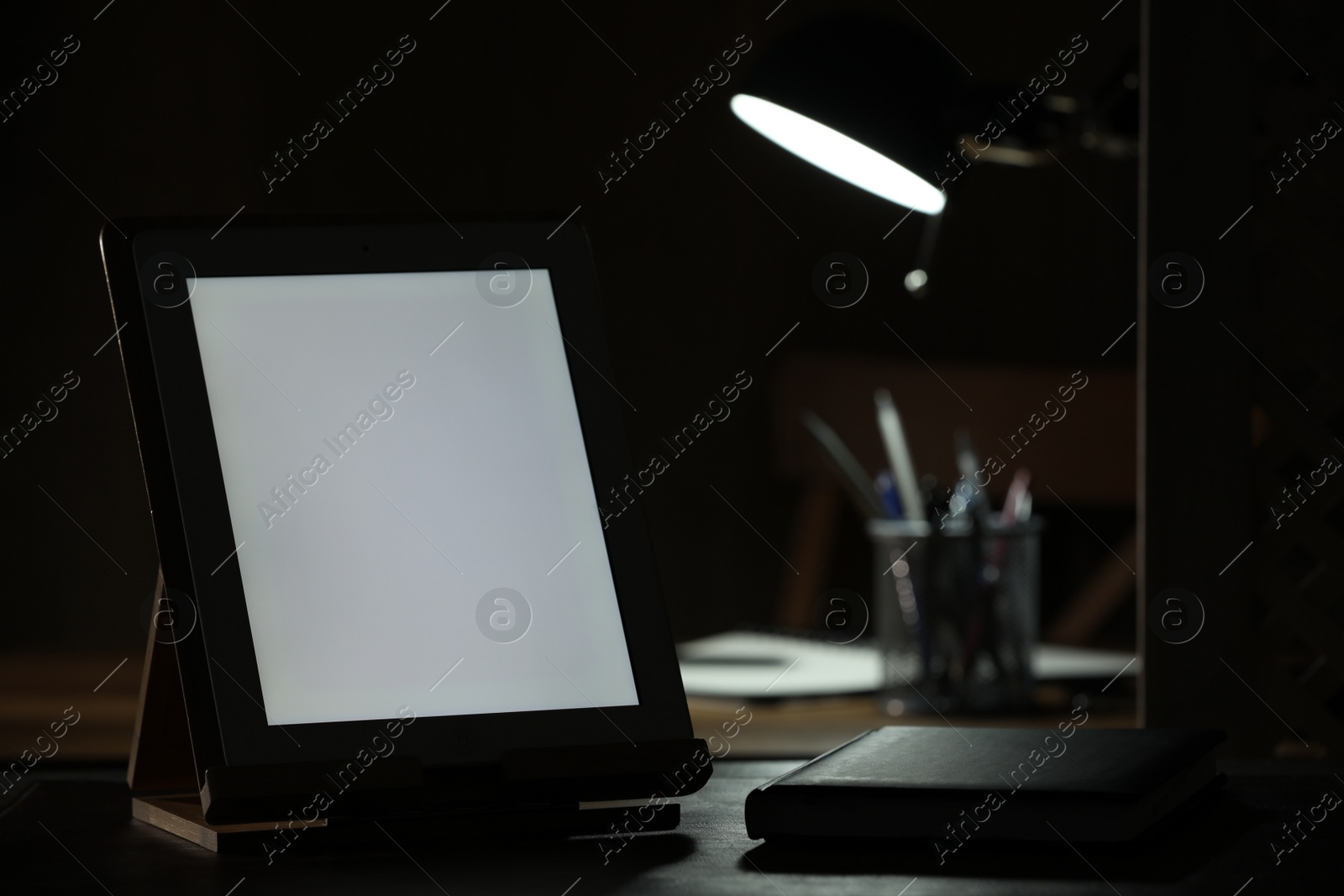 Photo of Modern tablet and planner on table indoors. Space for text