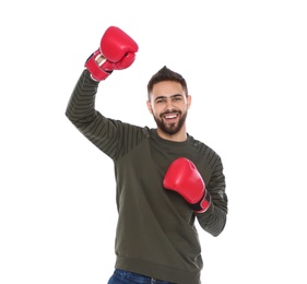 Photo of Happy young man with boxing gloves celebrating victory on white background
