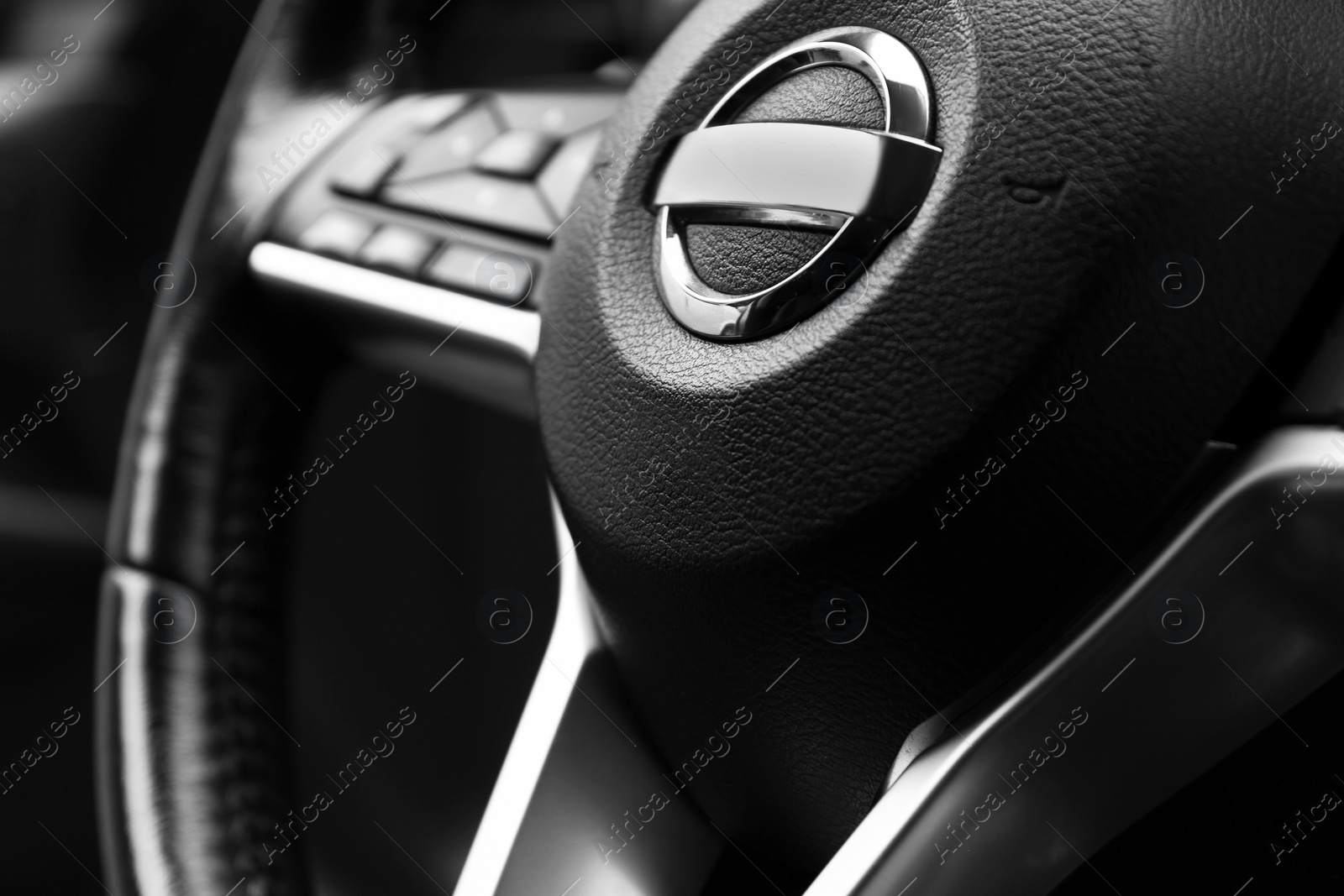 Photo of Safety airbag sign on steering wheel in car, closeup