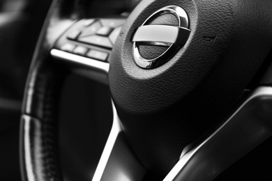 Safety airbag sign on steering wheel in car, closeup