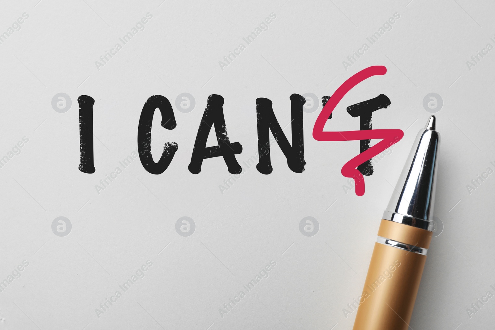 Image of Phrase I CAN'T with crossed out letter T and pen on white background, top view. Motivation and positivity