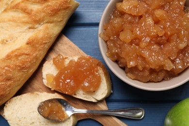 Flat lay composition with delicious apple jam on blue wooden table