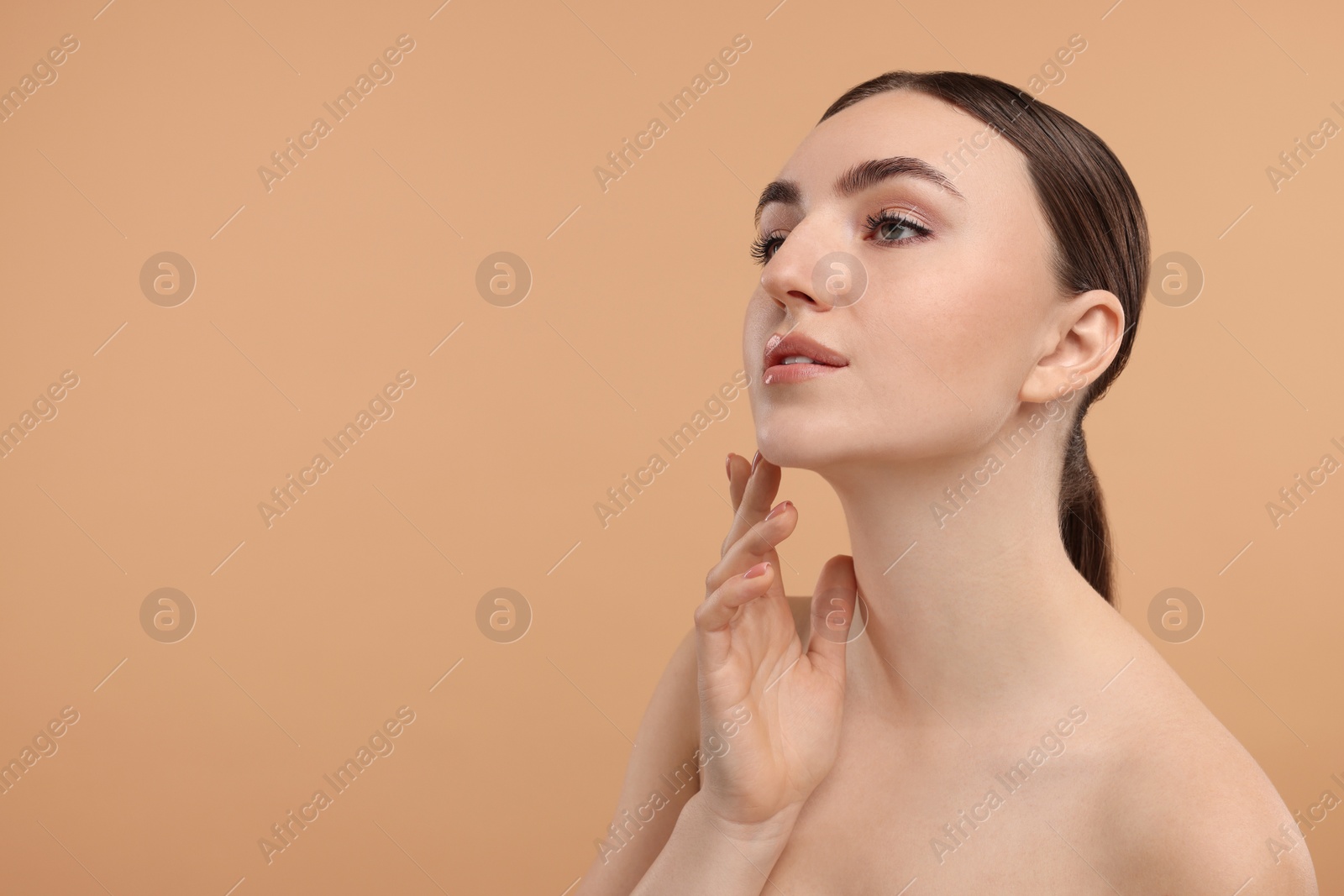 Photo of Beautiful woman touching her neck on beige background. Space for text