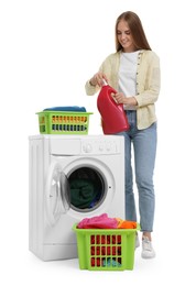 Beautiful young woman with detergent and laundry near washing machine on white background