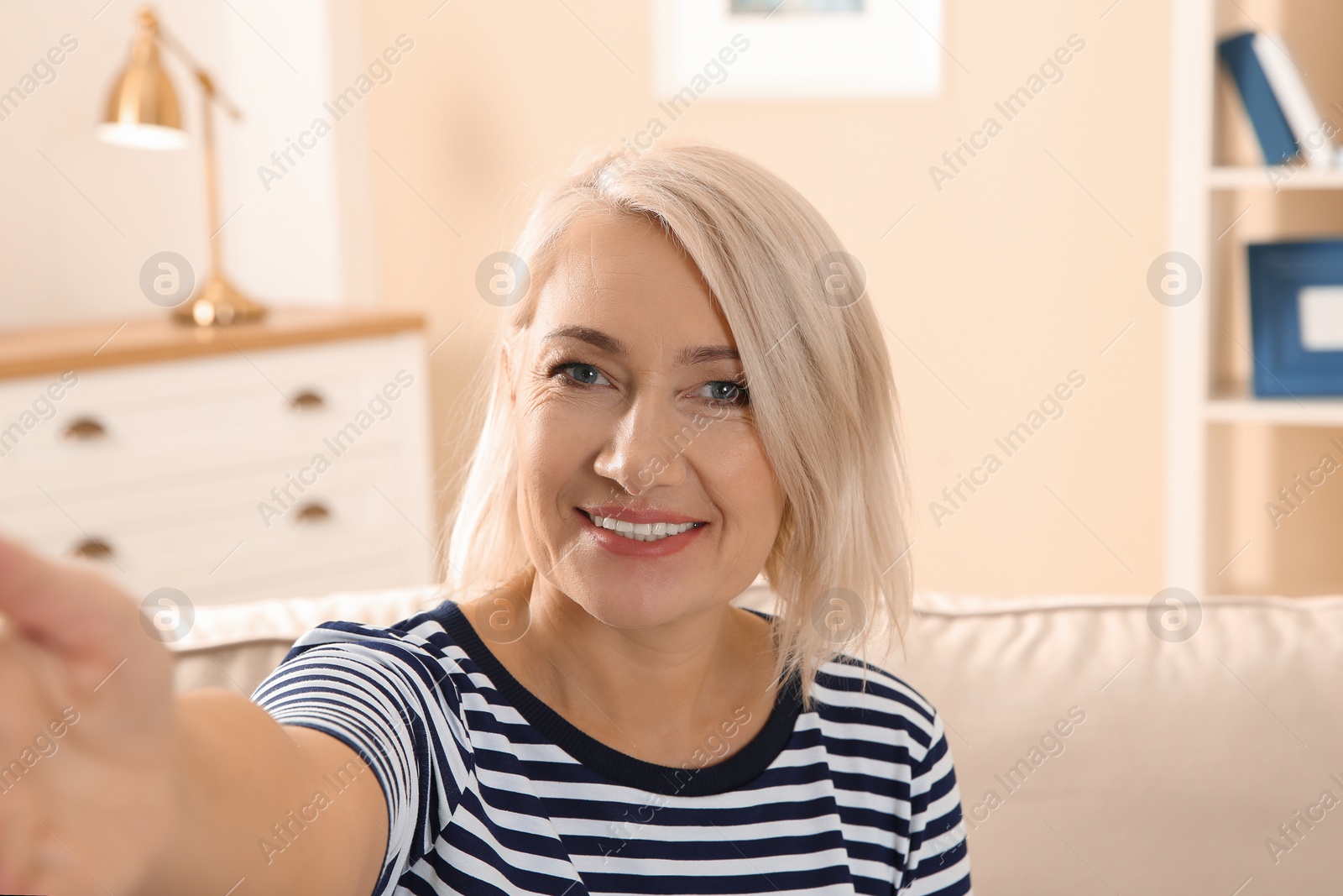 Photo of Mature woman using video chat at home, view from web camera